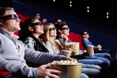 A Set of People Enjoying A 3D Movie In Theatre.