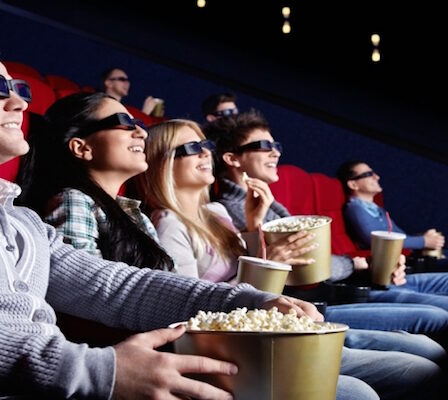 A Set of People Enjoying A 3D Movie In Theatre.