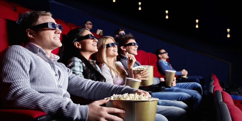 A Set of People Enjoying A 3D Movie In Theatre.
