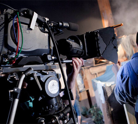 A Commercial Movie Director Standing Infront of The Professional Camera.