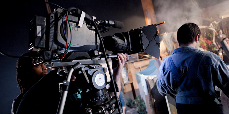 A Commercial Movie Director Standing Infront of The Professional Camera.