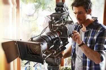 A Camera Man Working With A Professional Film Camera For A Commercial Film.