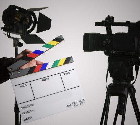 A Person Holding The Movie Clapboard.