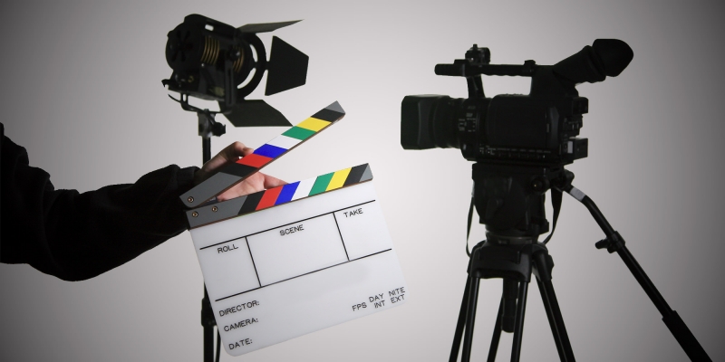 A Person Holding The Movie Clapboard.