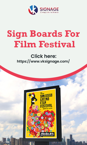 A Bright Colored Vertical Sign Board Advertisement About The Film Festival On The City Street In The Sky Background.